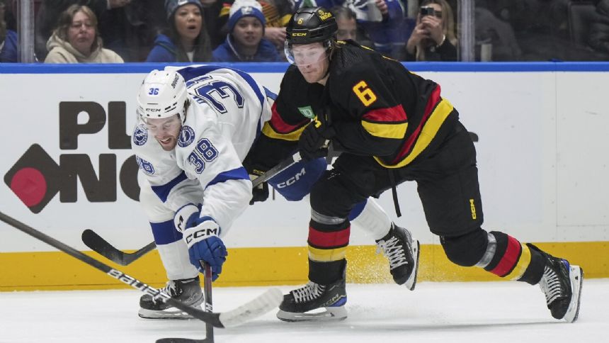 Boeser nets hat trick to tie for NHL goals lead and Canucks beat Lightning 4-1