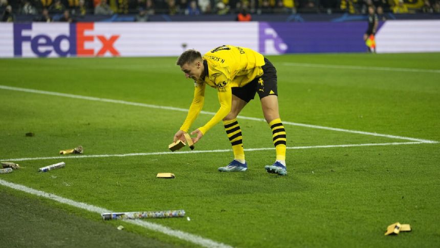 Borussia Dortmund fans throw fake money to protest UEFA's planned Champions League reforms