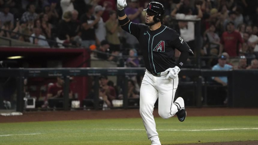 Eugenio Suarez homers, drives in 3 runs to help the Diamondbacks rally past the Braves, 7-5