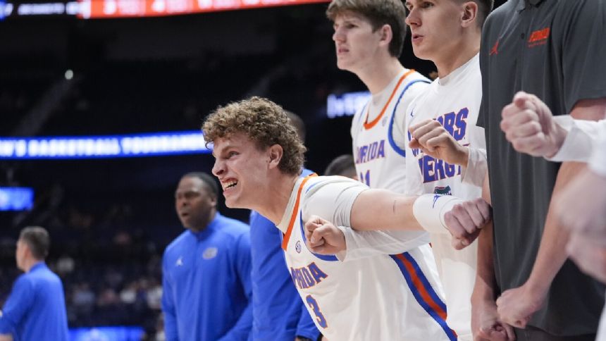 Florida center Micah Handlogten stretchered off court early at the SEC final with leg injury