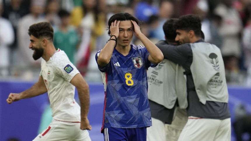 Iran beats Japan 2-1 to reach Asian Cup semifinals with Jahanbakhsh's late penalty. Host Qatar wins