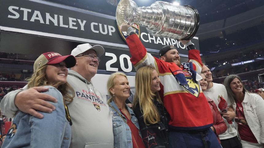 Matthew Tkachuk celebrates winning Stanley Cup with dad Keith and brother Brady