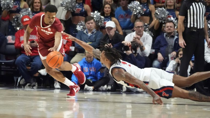 No. 14 Alabama retains a share of 1st place in the SEC with a 103-88 win over Mississippi