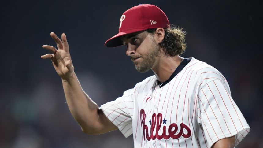 Nola, Schwarber help the Phillies beat the Brewers 4-3 for their 4th straight victory