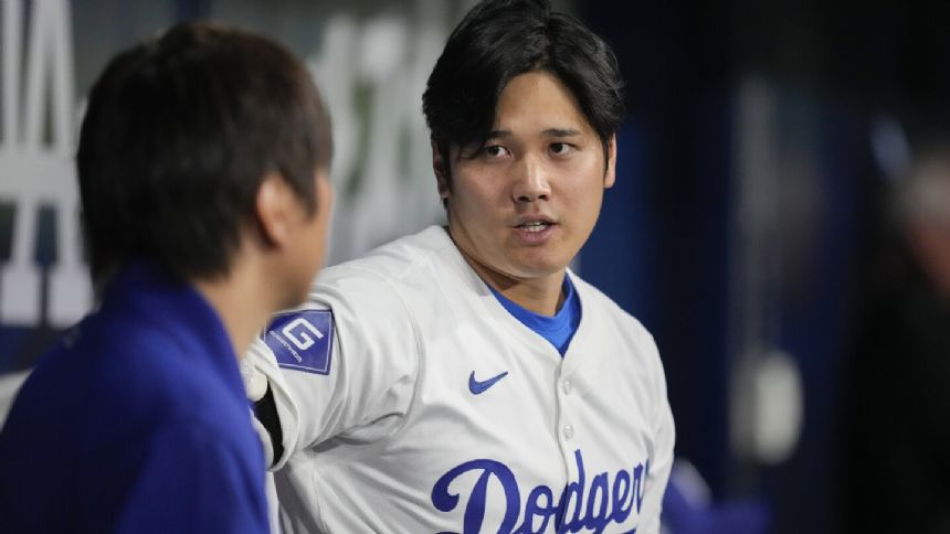 Ohtani to begin throwing program soon. Roberts hints Dodgers star might play in the field