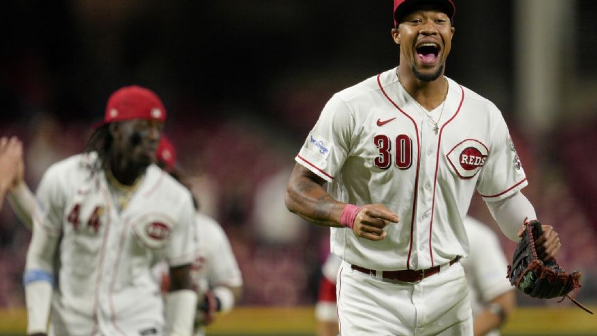 Phillips gets first major league win and Benson had 3 RBIs to lead Reds over Twins 7-3