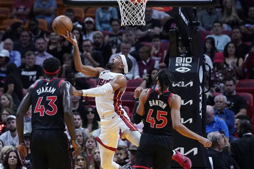 Raptors clamp down on Miami, top Heat 98-90 for split