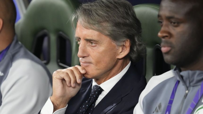 Saudi Arabia coach Roberto Mancini walks off before the end of penalty shootout at the Asian Cup