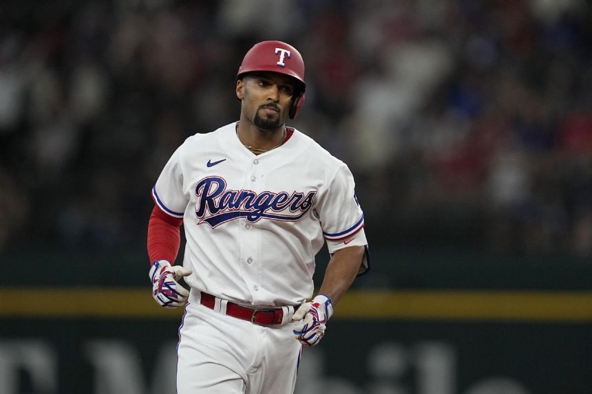 Semien hit streak reaches 22, Rangers rough up Mariners 16-6 in Woo debut