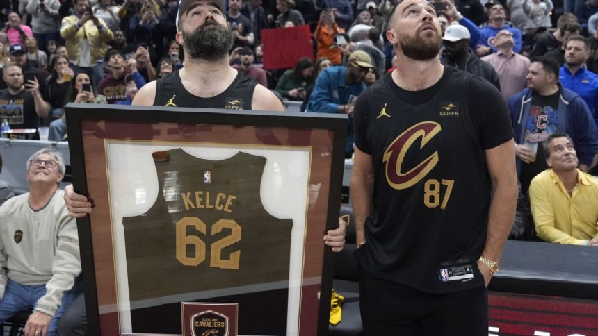 Travis and Jason Kelce attend bobblehead giveaway. Cavaliers give Jason a framed No. 62 jersey
