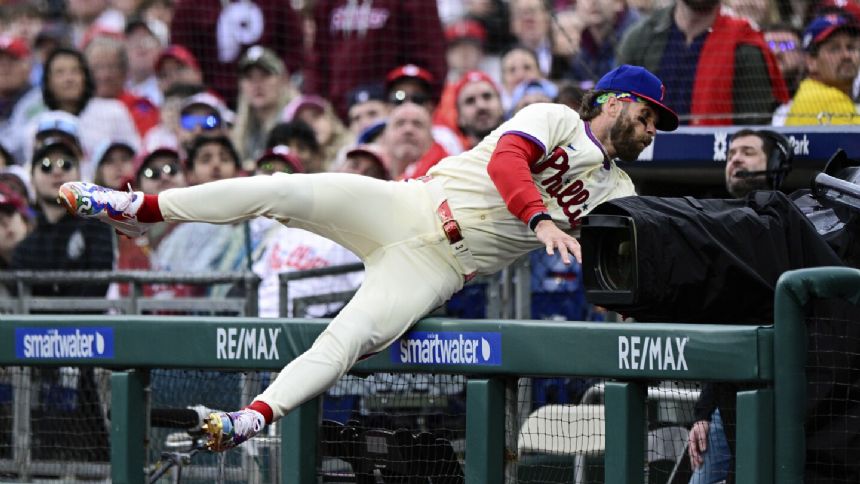 Tumbling Bryce: Harper gives Phillies scare with crash landing in photo well