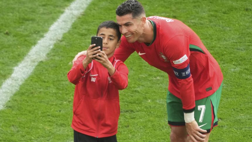 Young fan takes selfie with Cristiano Ronaldo during match at Euro 2024